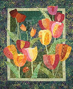 a quilted wall hanging with flowers on it