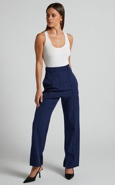 Slay the pants game with our Rogers Pants in Navy! These tailored pants are perfect for both workwear and casual occasions. The navy color adds a touch of sophistication, while the full-length style keeps you looking stylish all summer long.Pair them with your favorite high heels to elongate those legs and show off your feminine side. You'll love how comfortable these pants feel, making them the perfect addition to your wardrobe. Don't let another day go by without these must-have Rogers Pants - Summer Wide Leg Elastane Pants For Work, Elegant Stretch Navy Pants, Summer Business Casual Elastane Bottoms, Summer Tapered Leg Elastane Pants, Summer Stretch Tapered Leg Pants, Chic Navy Fitted Pants, Chic Fitted Navy Pants, Ankle-length Elastane Dress Pants For Summer, Navy Stretch Pants For Business Casual