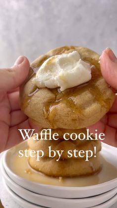 a person holding up a stack of cookies with cream on top and the words crumb waffle cookies above it