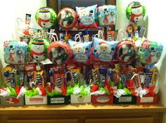 a table topped with lots of christmas themed items and balloons in the shape of snowmen