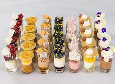 an assortment of desserts and pastries arranged in rows