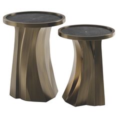 two side tables made out of metal, one is gold and the other is black