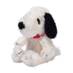 a white stuffed dog with black and red collar sitting up against a white background,