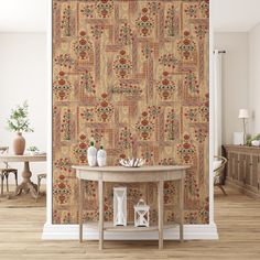 a table with two vases on it in front of a wallpapered room