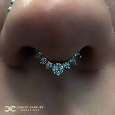 a close up view of the side of a woman's nose with diamonds on it