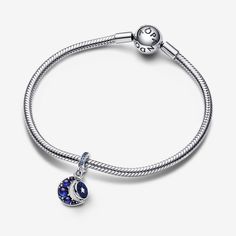 Sparkling blue stones and shimmering enamel come together in the Sparkling Moon Spinning Dangle Charm. This charm features a crescent moon shape set with smooth cabochon-cut man-made crystals in three different shades of blue, creating a dreamy effect. The small sterling silver disc inside the curve of the moon is designed to spin and features shimmering enamel on one side and a "Dreams come true" engraving on the other. Wear this sterling silver dangle charm to inspire you to pursue your dreams, every day. - Pandora Sparkling Moon Spinning Dangle Charm - Enamel / Sterling silver / Man-made crystal / Blue Pursue Your Dreams, Blue Stones, Moon Shape, Mesh Bracelet, Crystal Blue, Moon Shapes, Dangle Charms, Dreams Come True, Lab Created Diamonds