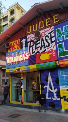 a colorful building with people standing outside it