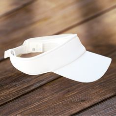 a white visor sitting on top of a wooden table