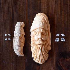 two carved wooden faces on a wood table