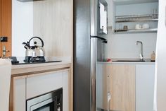 a tea kettle sitting on top of a kitchen counter next to a stove and sink