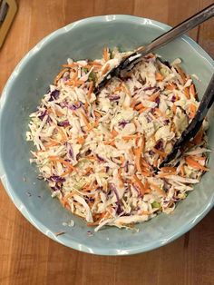 a blue bowl filled with coleslaw and carrots