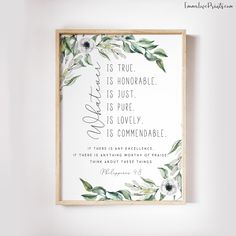 a white and green floral print with the words love is true, as shown on a wooden frame