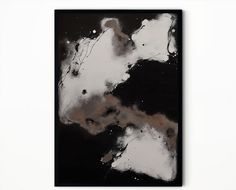 a black and white abstract painting hanging on a wall