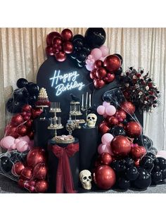 a birthday party with balloons and skulls