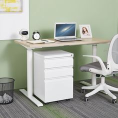 an office desk with a laptop on top of it and a chair next to it