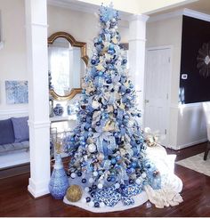 a blue and white christmas tree in a living room