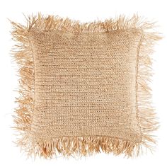 a beige pillow with fringes on the front and back of it, against a white background