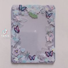 a glass frame with butterflies and flowers on it