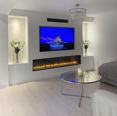 a large flat screen tv mounted to the side of a wall in a living room