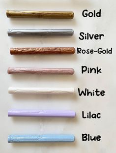 six different colored pens are lined up on a white surface with the words gold, silver, rose - gold, pink, white, lilac and lilac