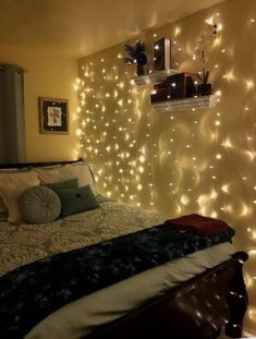 a bedroom with lights on the wall and a bed in it's centerpiece