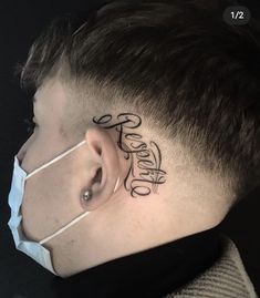 a man's ear with the word faith tattooed on his side behind his ear