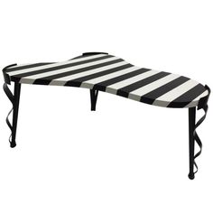 a black and white striped bench with wheels on the bottom, sitting in front of a white background