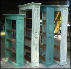 two tall wooden bookshelves sitting next to each other