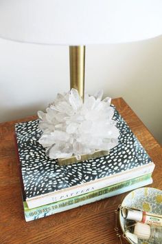 a table with a lamp and books on it