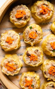 small dumplings with carrots and meat in a wooden bowl on a table top