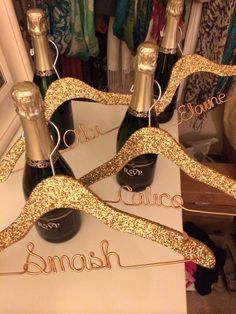 two bottles of champagne are sitting on top of a sign that says,'someone is wine