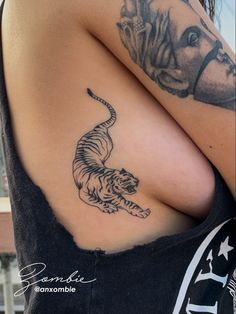 a woman with a tiger tattoo on her shoulder