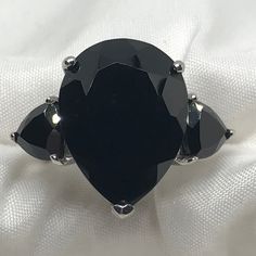 This Ring Will Definitely Get Noticed. Large Center Pear Shaped Black Spinel 19.45 Ct Flanked By A Trillion On Either Side For A Total Of 22.60 Ctw. Platinum Over Sterling Silver Raised Setting. Trilogy Rings Have Been Around For Years And Can Be Symbolic Of Many Things. Nwot Happy Poshing!!! Women’s Jewelry, Genuine Gemstones, Tanzanite, Black Spinel, Platinum, Aquamarine, Ruby, Sapphire, London Blue Topaz, Blue Topaz, Larimar, Madeira Citrine, Rainbow Moonstone, Goshenite, Sleeping Beauty Turq Elegant Black Rings For Party, Elegant Black Party Rings, Black Ring For Evening Jewelry, Classic Black Pear-shaped Jewelry, Black Oval Jewelry For Party, Trilogy Rings, Black Spinel Ring, Spinel Ring, Imperial Topaz