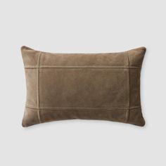 a brown pillow on a white background