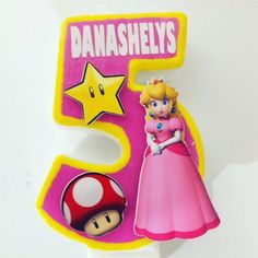 there is a pink and yellow number 5 with a mario bros figure next to it