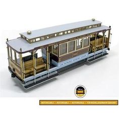 the trolley car is painted in gold and silver