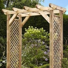 an outdoor wooden arbor with trelliss and flowers