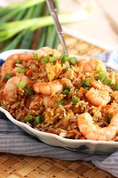 a bowl filled with shrimp and rice on top of a table