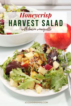 a white plate topped with salad next to an apple