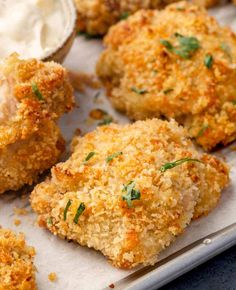 chicken nuggets on a baking sheet with butter and parsley