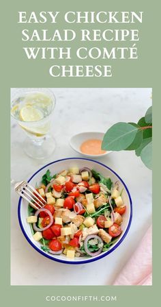 a salad with tomatoes, cucumbers and onions in a blue and white bowl