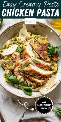 chicken pasta in a bowl with spinach leaves and parmesan cheese on the side