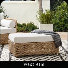 two wicker chairs sitting on top of a rug