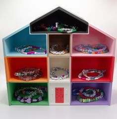 a multicolored shelf with many bracelets and beads on it's sides