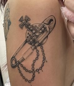 a woman's thigh with a tattoo on it and a chain attached to the leg