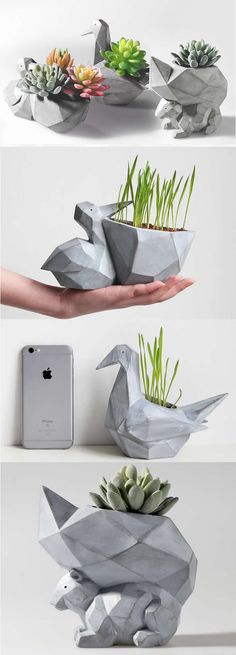 some paper birds with succulent plants in their beaks and one is holding an iphone