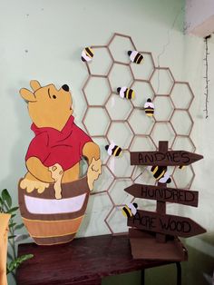 a winnie the pooh potted in front of a honeycomb with bees on it