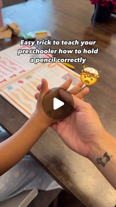 a person holding an object in their hand with the caption easy trick to teach your preschool how to hold a pencil correctly