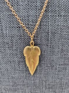 This nature-inspired handmade solid leaf necklace has an 18-inch gold-plated chain and clasp, with a 3cm/1.18-inch leaf pendant- an excellent accessory for any Fall outfit. Leaves symbolize growth and rebirth. Gift the earrings and necklace set to a new graduate in the family or show your support to someone going through significant changes in their life. Necklace measurements: Chain Length: 18 inches / 45.72cm Pendant: 1.18 inches / 3cm Nature-inspired Gold Teardrop Pendant Jewelry, Leaf-shaped Yellow Gold Necklace For Gift, Leaf-shaped Yellow Gold Necklace, Gold Nature-inspired Necklace With Large Pendant, Gold Leaf Nature-inspired Jewelry, Gold Leaf-shaped Nature-inspired Necklace, Nature-inspired Gold Leaf-shaped Jewelry, Nature-inspired Gold Leaf Necklace, Nature-inspired Leaf-shaped Brass Jewelry