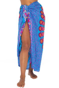 Brilliantly exotic, this sexy, lightweight beach sarong lures admiring eyes with its stunning peacock design. A mandala of painted feathers ripples out from the center, giving you every reason to strut your beauty by beach or poolside. Just cinch to fit with the coconut shell buckle to wear as a sarong dress, wrap skirt, bathing suit cover up or night-out shawl. Or use it to makes waves on the beach or at home as a lightweight blanket or tablecloth. Back From Bali is dedicated to creating beautiful, quality clothing with a heart. All of our items are crafted, sewn and painted by hand in Bali, by local artists and women who own small home businesses. For over 20 years, we have nurtured fair, honest and caring relationships with our artisans and their families – so you can feel as good about Multicolor Bohemian Sarong For Festivals, Bohemian Multicolor Sarong For Festivals, Red Bohemian Sarong For Festivals, Multicolor Bohemian Sarong With Vibrant Print, Bohemian Multicolor Sarong With Vibrant Print, Bohemian Multicolor Vibrant Print Sarong, Skirt Bathing Suit, Circular Mandala, Shell Clip